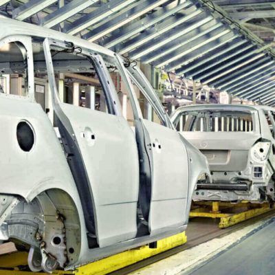 Car bodies on an assembly line in various stages of completion