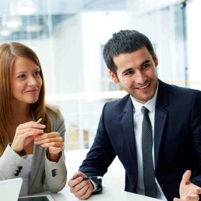 Business partners collaborating on documents at a meeting.