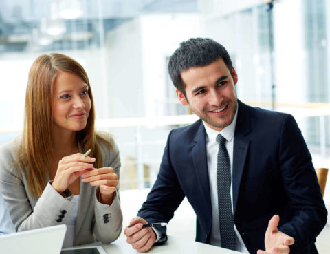 Business partners collaborating on documents at a meeting.