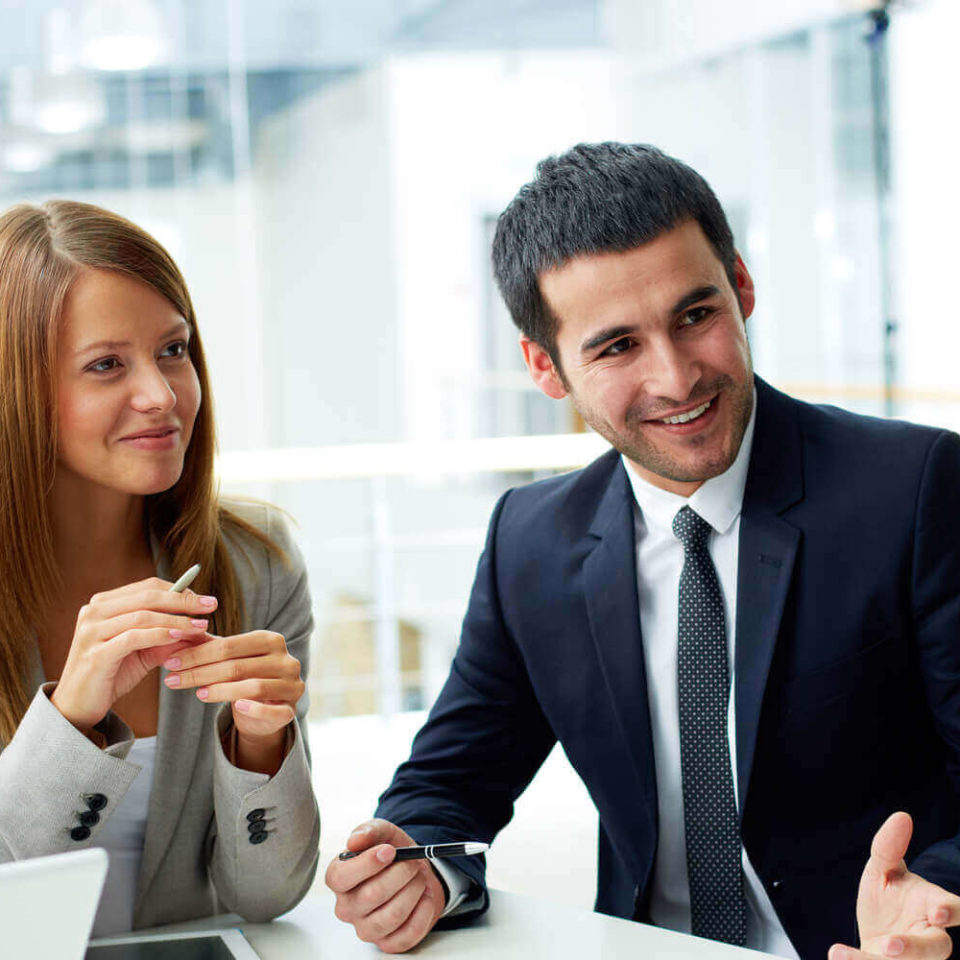 Business partners collaborating on documents at a meeting.