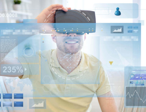 A person wearing a virtual reality headset interacting with a data visualization projected onto a screen.