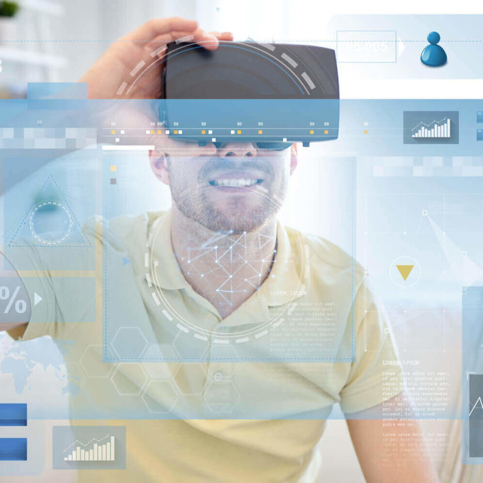 A person wearing a virtual reality headset interacting with a data visualization projected onto a screen.
