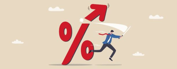 Illustration of a man slicing off a percent sign, signifying interest rate reduction