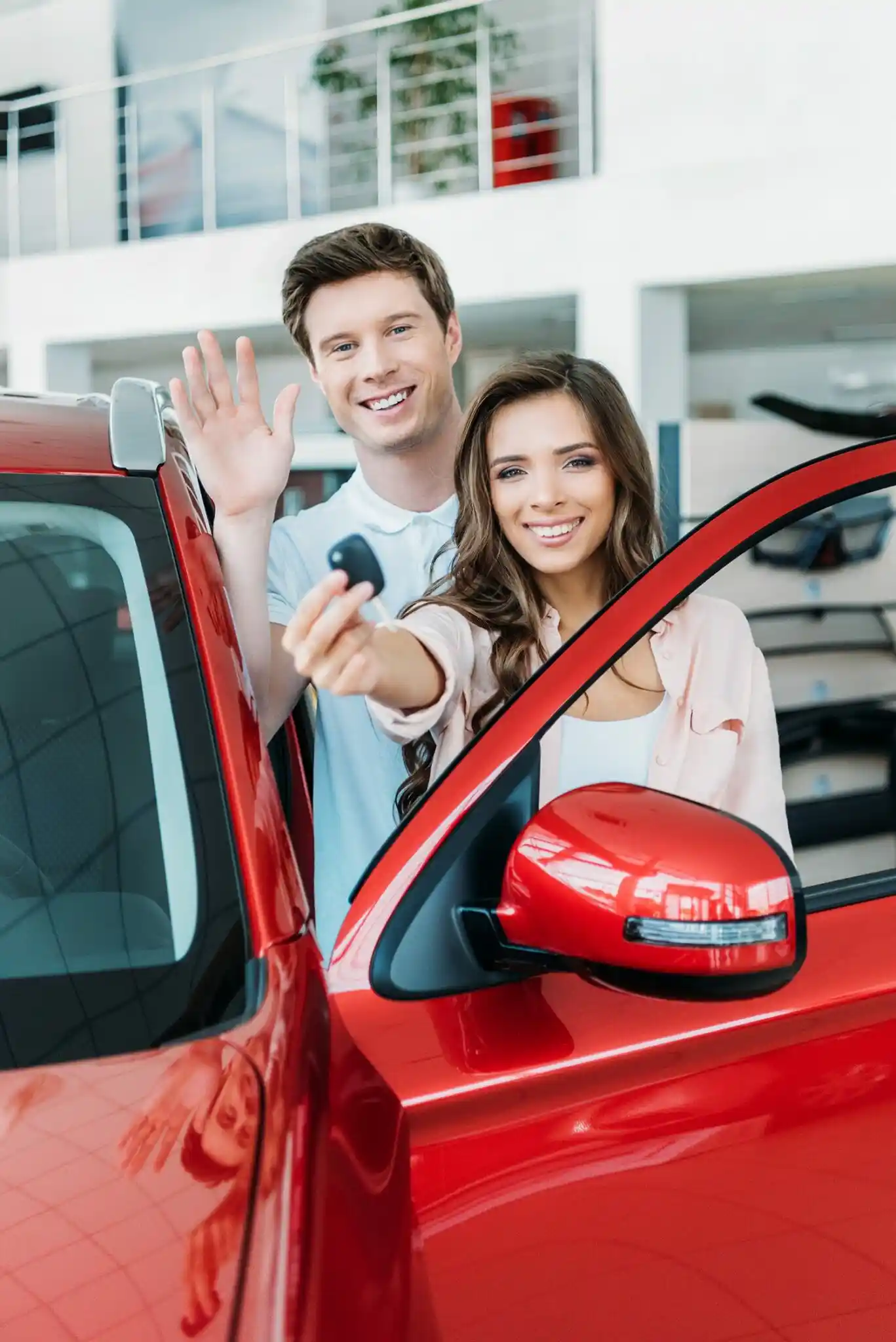 Couple smiling beside their newly bought car | Secured Loans